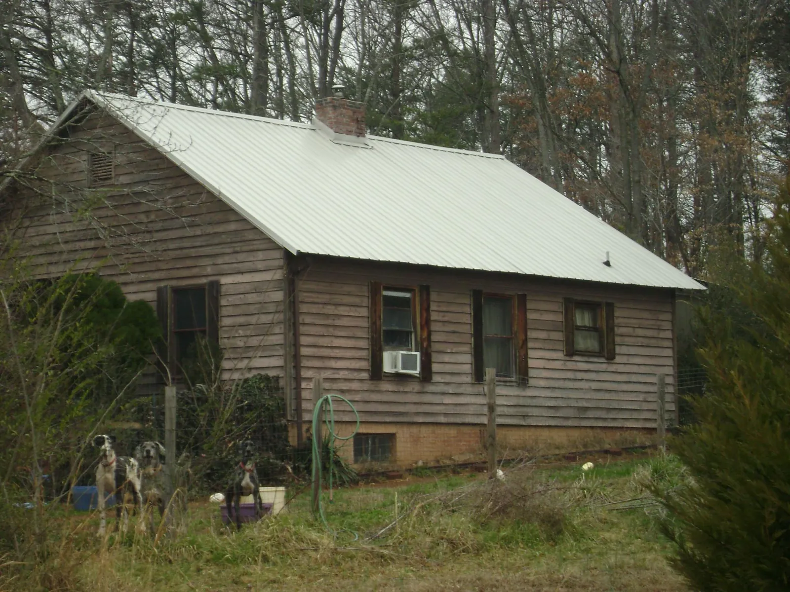 White metal roof on an old wood sided farmhouse, from a Metal Roof Installation job in Beaver